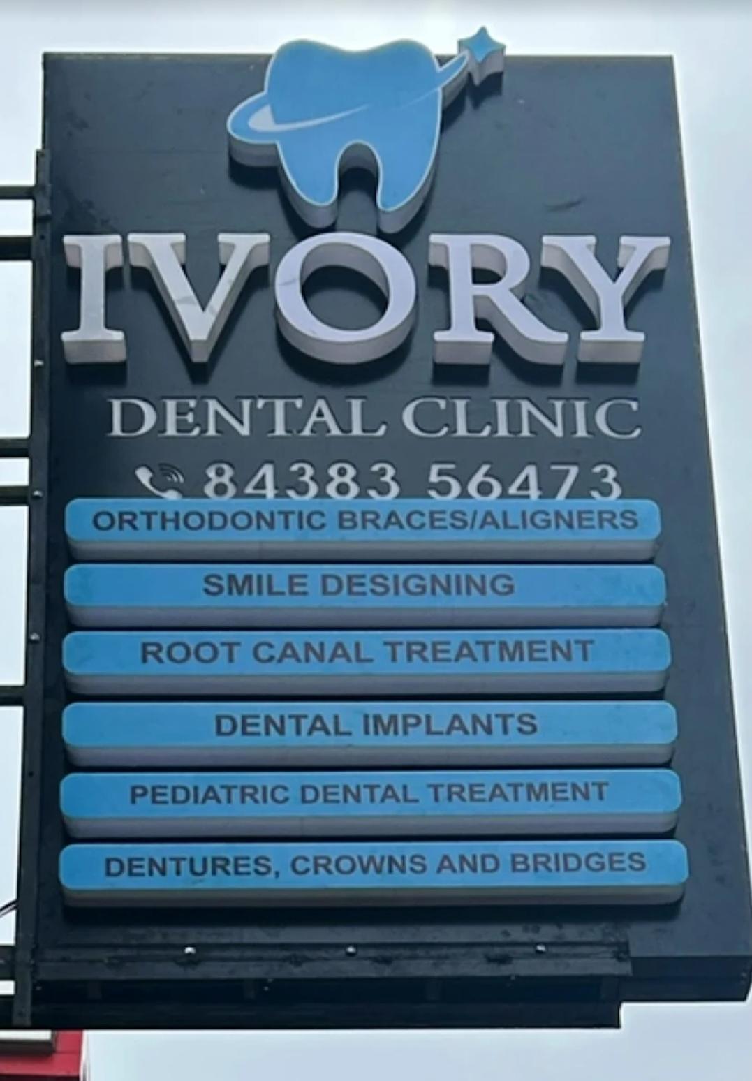 Dentist at Ivory Dental Clinic reviewing a patient's scan
